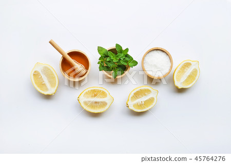 Honey , lemon, mint and salt on white background. Honey , lemon, mint and salt on white background. 45764276