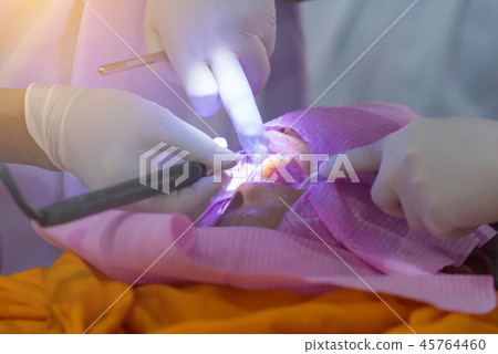 The doctor cleaning the teeth patient The doctor cleaning the teeth patient 45764460