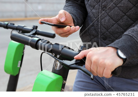 man on an electric scooter paying online 45765231