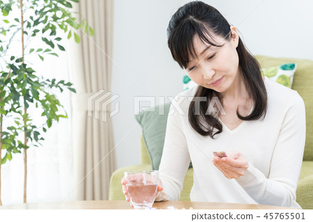 Woman taking medicine Woman taking medicine 45765501