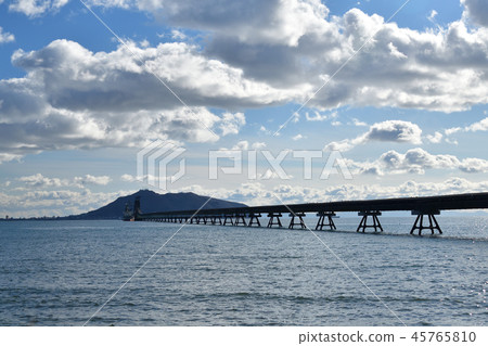 Taking a picture of the landscape of a conveyor belt carrying raw materials to a cement plant in Kamisu area, Hokuto City, Hokkaido 45765810