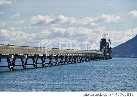 Taking a picture of the landscape of a conveyor belt carrying raw materials to a cement plant in Kamisu area, Hokuto City, Hokkaido 45765812