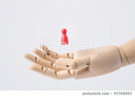 wooden hand with red chess isolated on white 45768983