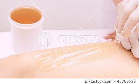 Depilation spa procedure. Woman hair remove waxing 45769559