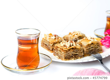 Baklava and turkish tea on white background Baklava and turkish tea on white background 45774799