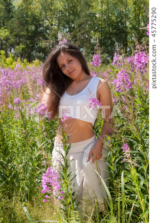 Attractive girl on meadow 45775290