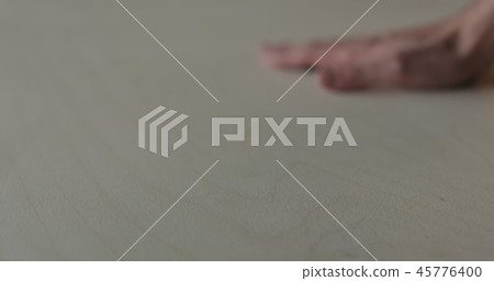 closeup man hand touches plywood to check surface closeup man hand touches plywood to check surface 45776400