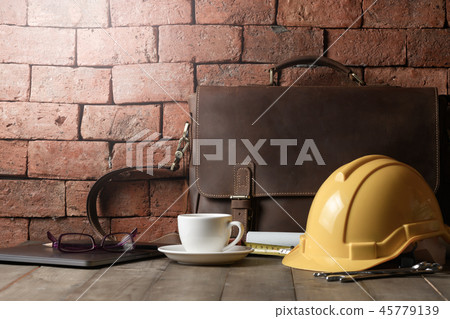 vintage leather bag with safety helmet and tool 45779139