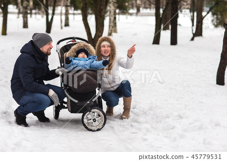Happy young family walking in the park in winter 45779531