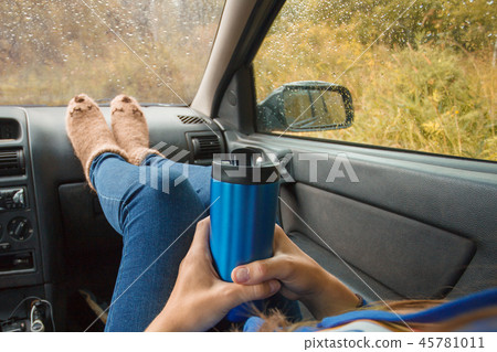Woman legs in warm cute socks on car Woman legs in warm cute socks on car 45781011