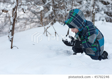 Boy eating snow in winter. 45782246