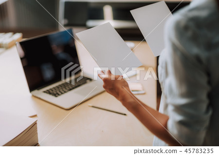 Young lady holding two blank paper cards at office Young lady holding two blank paper cards at office 45783235