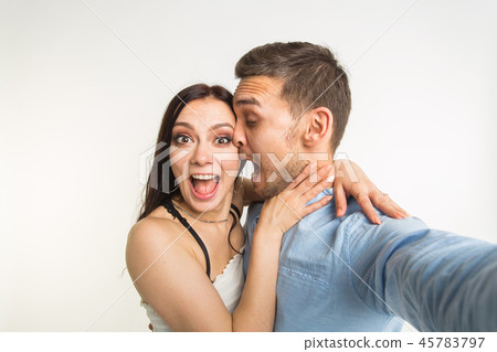 Funny couple taking selfie photo, isolated studio shot Funny couple taking selfie photo, isolated studio shot 45783797