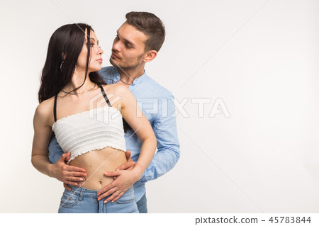 Young man hugging his girlfriend on white background with copy space Young man hugging his girlfriend on white background with copy space 45783844