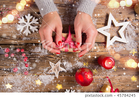 Top view of woman hands with gift box. Top view of woman hands with gift box. 45784245