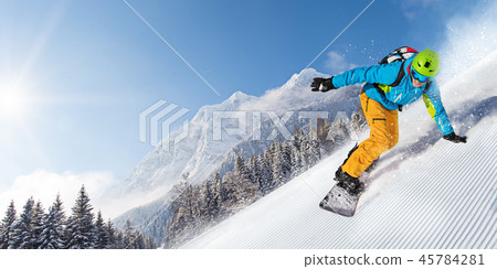 Man snowboarder riding on slope. 45784281