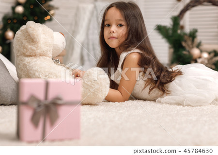 cute child girl playing with teddy bear at home 45784630
