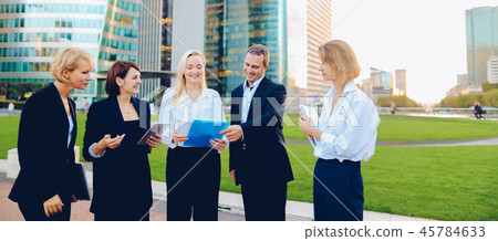 Management team changing ideas about new project with tablet and Management team changing ideas about new project with tablet and 45784633