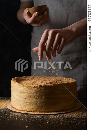 Woman decorating traditional napoleon cake 45785135