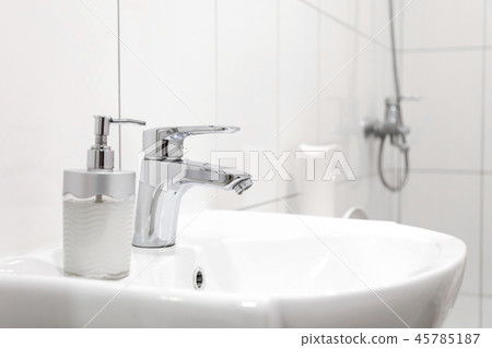 white sink with Steel faucet in a bathroom white sink with Steel faucet in a bathroom 45785187