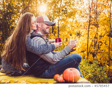 Attractive man and stylish woman holding a mobile phone Attractive man and stylish woman holding a mobile phone 45785457