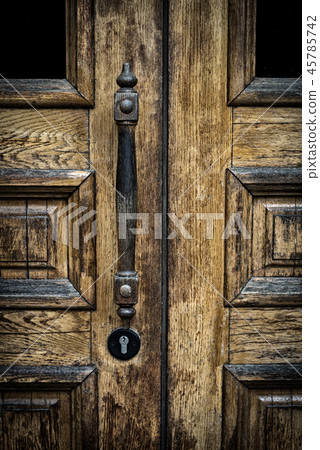 old wooden entrance door with antique door handle. old wooden entrance door with antique door handle. 45785742