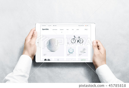 Hands holding tablet with sport webstore mock up on screen Hands holding tablet with sport webstore mock up on screen 45785818