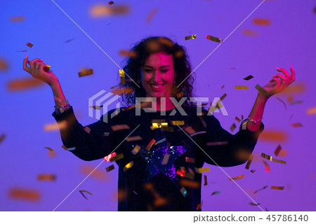 Portrait of beautiful woman playing with confetti . Celebration, Birthday, Christmas, New Year. Portrait of beautiful woman playing with confetti . Celebration, Birthday, Christmas, New Year. 45786140