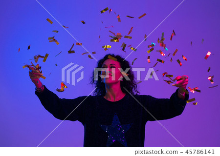Portrait of beautiful woman playing with confetti . Celebration, Birthday, Christmas, New Year. Portrait of beautiful woman playing with confetti . Celebration, Birthday, Christmas, New Year. 45786141