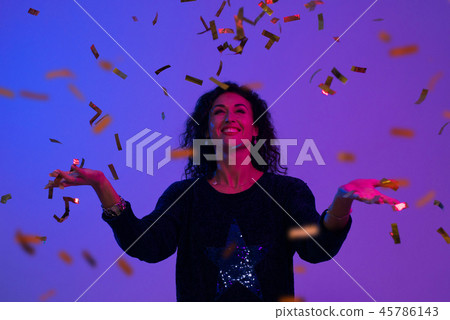 Portrait of beautiful woman playing with confetti . Celebration, Birthday, Christmas, New Year. Portrait of beautiful woman playing with confetti . Celebration, Birthday, Christmas, New Year. 45786143