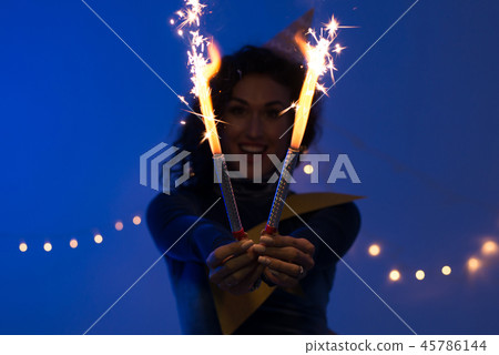 Young woman holding fireworks. Holiday, Event, celebration Young woman holding fireworks. Holiday, Event, celebration 45786144