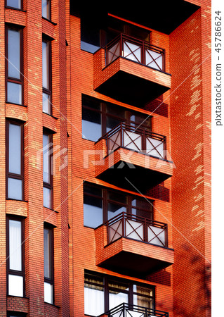 Facade of a red multi-storey building. Fragment. Facade of a red multi-storey building. Fragment. 45786624