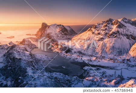 Aerial view of snowy mountains, blue sea at sunset Aerial view of snowy mountains, blue sea at sunset 45786948