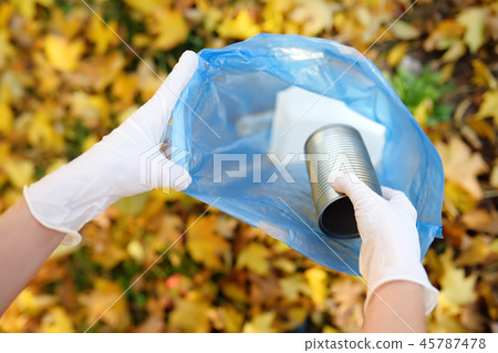 Volunteer picking up the garbage outdoors. 45787478
