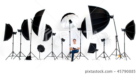 Asian photographers sit on the director's chair with flash studi Asian photographers sit on the director's chair with flash studi 45790885