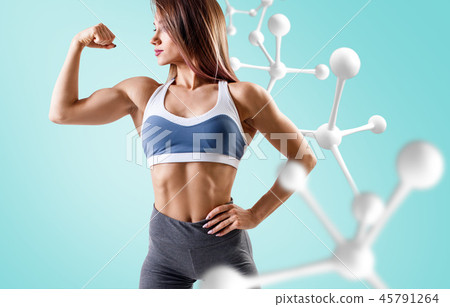 Athletic fitness woman standing near white molecule chain. 45791264