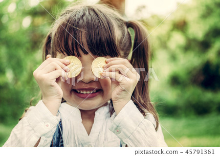 Little girl kid holding bitcoin digital money. Little girl kid holding bitcoin digital money. 45791361