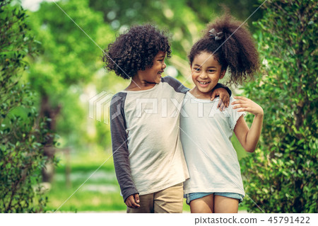 Happy little boy and girl in the park. Happy little boy and girl in the park. 45791422