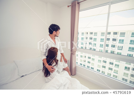 Happy young couple relaxing in the home bedroom. 45791619