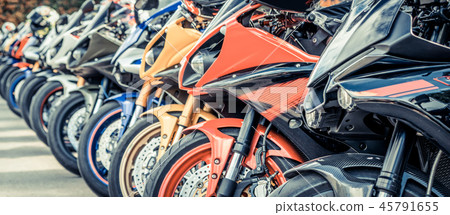 Motorcycles group parking on city street in summer Motorcycles group parking on city street in summer 45791655
