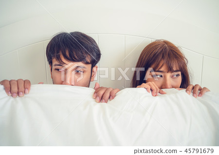 Happy young couple relaxing in the home bedroom. 45791679