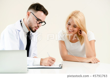 Male Doctor and Female Patient in Hospital Office 45791763