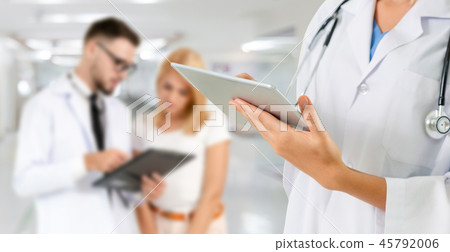 Doctor working in hospital with other doctors. Doctor working in hospital with other doctors. 45792006