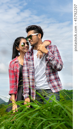 Happy couple take a romantic walk on the hills. 45792207