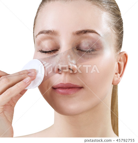 Woman cleaning her face by cotton disk. Skincare concept. Woman cleaning her face by cotton disk. Skincare concept. 45792755