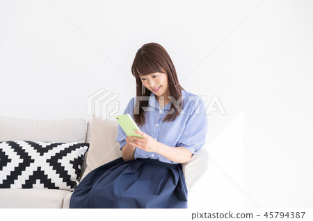 A woman watching a smartphone A woman watching a smartphone 45794387