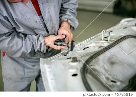 Car repair in car service. Locksmith grinds detail 45795819