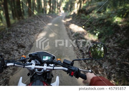 Motorcycle running on the road in the forest Motorcycle running on the road in the forest 45795857