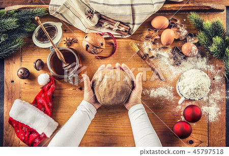 Gingerbread dough and woman hands preparing cakes. 45797518