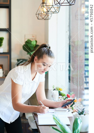 Young woman managing coffee shop business Young woman managing coffee shop business 45798842